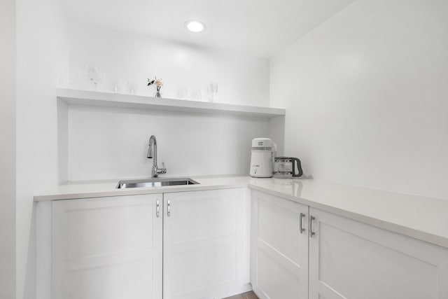 bar featuring recessed lighting and a sink