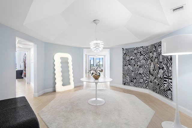 interior space with a notable chandelier and light wood-type flooring