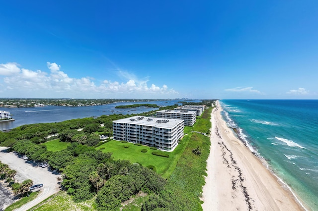 drone / aerial view with a water view and a beach view