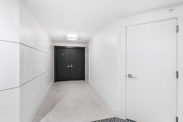 corridor featuring light tile patterned floors