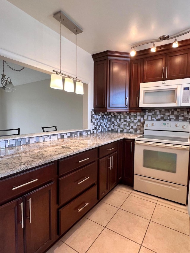 kitchen featuring decorative light fixtures, backsplash, light tile patterned floors, light stone counters, and white appliances