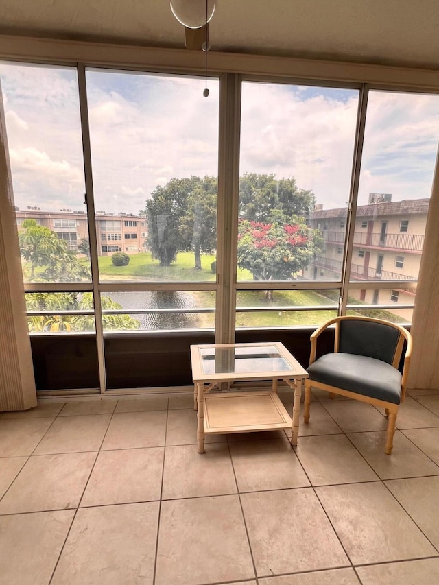 sunroom / solarium with a healthy amount of sunlight and a water view