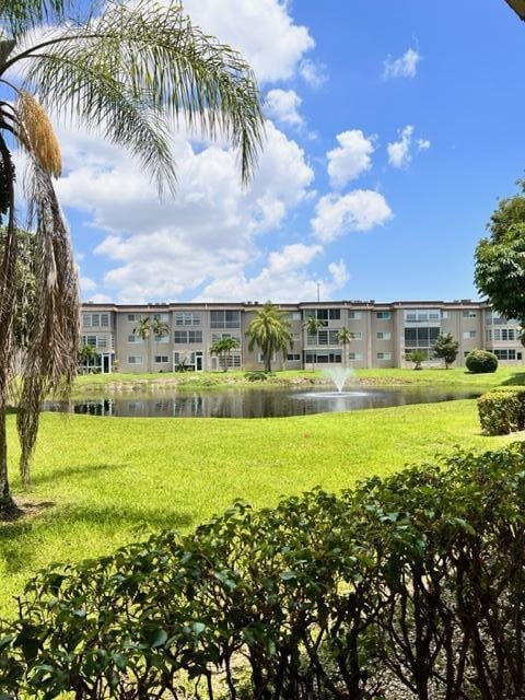 surrounding community with a lawn and a water view