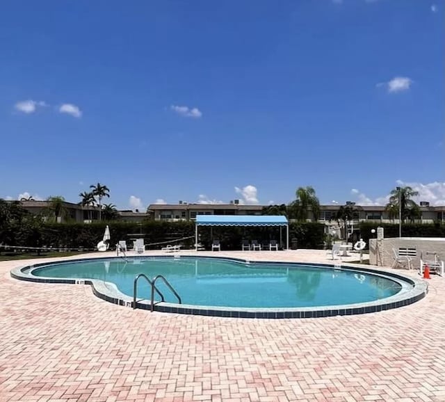 view of swimming pool featuring a patio area