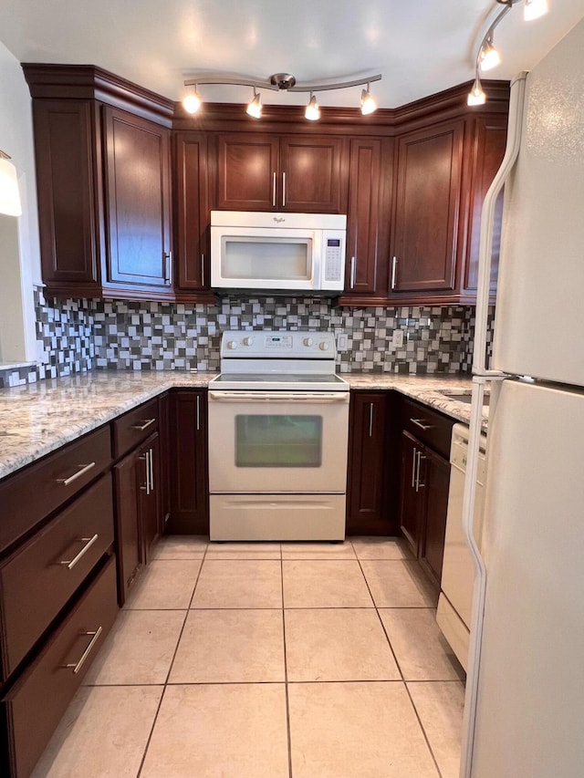 kitchen with white appliances, light stone counters, decorative backsplash, and light tile patterned flooring