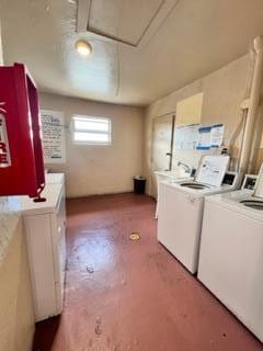 clothes washing area with separate washer and dryer