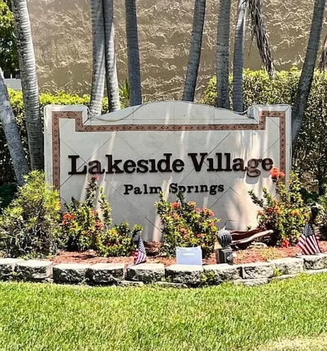 community / neighborhood sign with a water view