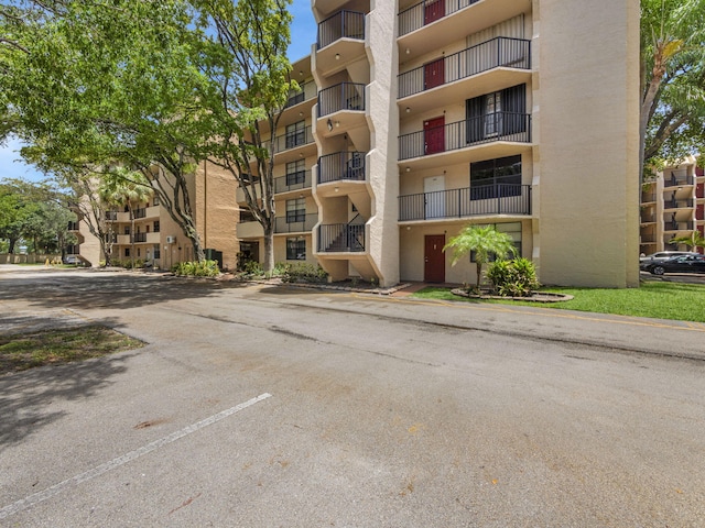 view of property featuring uncovered parking