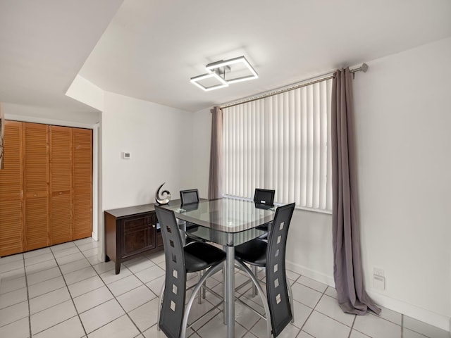 dining area featuring baseboards and light tile patterned floors