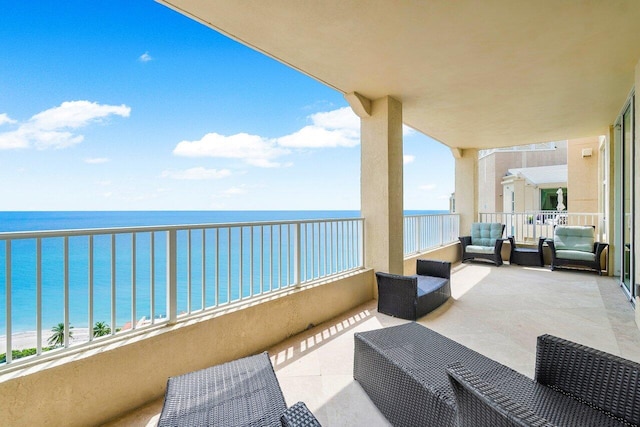 balcony featuring a water view and outdoor lounge area