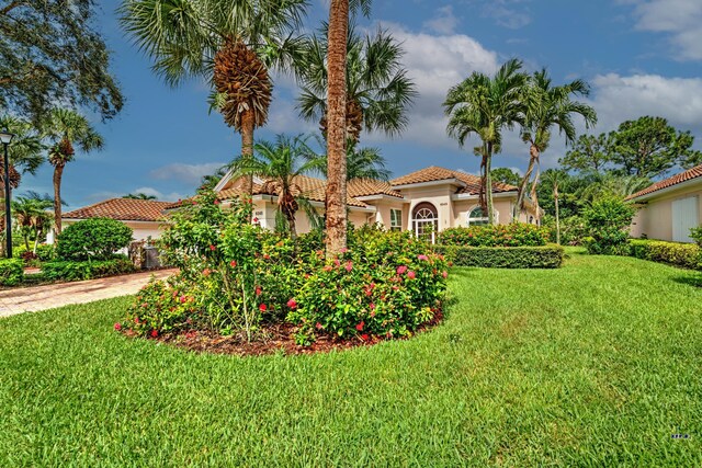 mediterranean / spanish-style house featuring a front yard