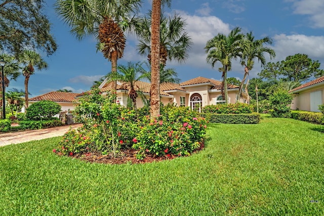 mediterranean / spanish-style home featuring a front lawn