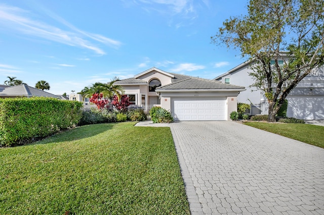 ranch-style house with a garage and a front lawn