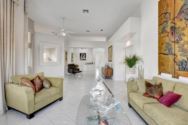 living area with visible vents, ceiling fan, and light tile patterned floors