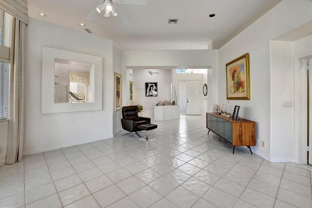 entryway with a ceiling fan, visible vents, plenty of natural light, and light tile patterned floors