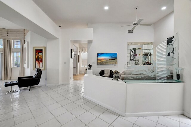 living room featuring light tile patterned floors, ceiling fan, baseboards, and recessed lighting