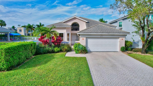 view of front of property with a garage and a front yard