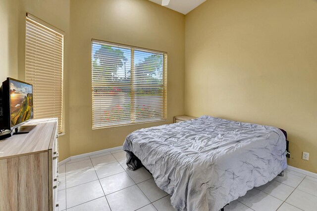 bedroom featuring baseboards and light tile patterned flooring