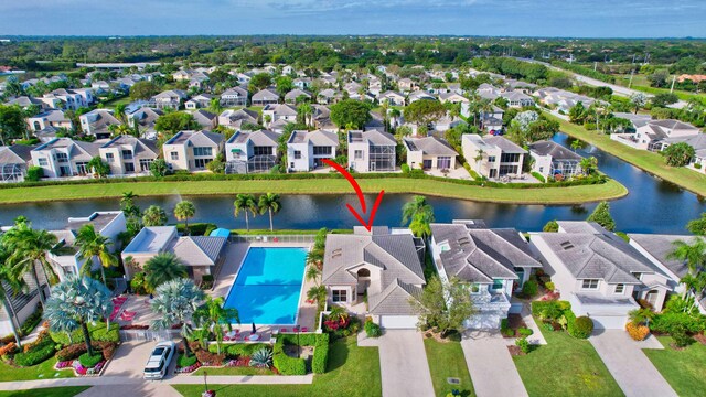 birds eye view of property featuring a water view and a residential view