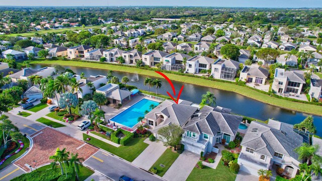 drone / aerial view featuring a water view and a residential view