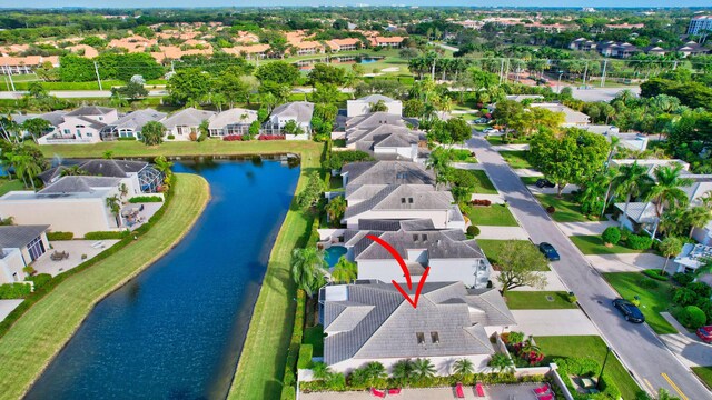 drone / aerial view with a water view and a residential view