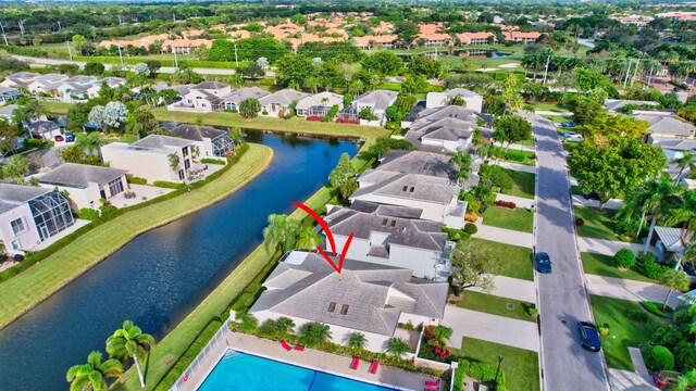 birds eye view of property with a water view and a residential view