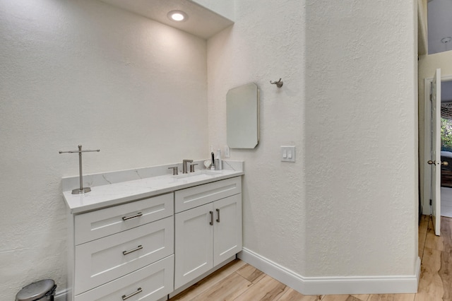 bathroom featuring vanity and hardwood / wood-style flooring