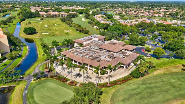 bird's eye view with a residential view, view of golf course, and a water view