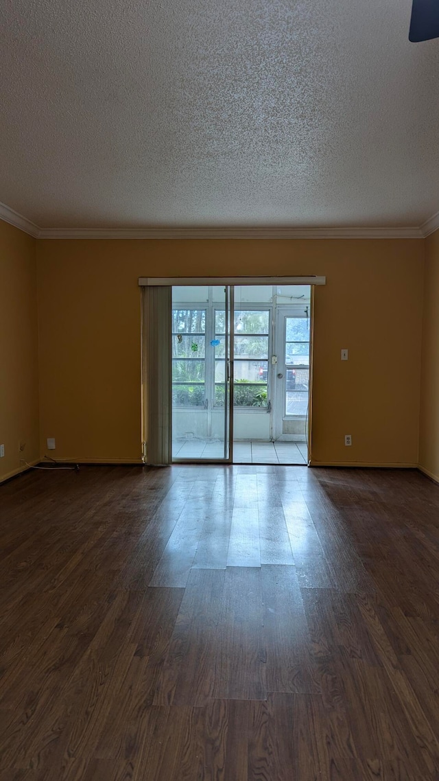 spare room featuring a textured ceiling, crown molding, and hardwood / wood-style floors