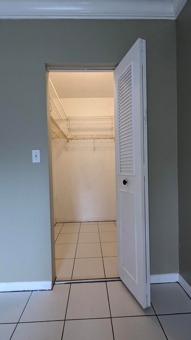 walk in closet with light tile patterned flooring