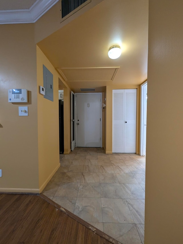 corridor featuring light tile patterned flooring and crown molding