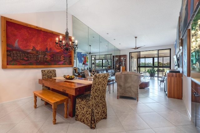 tiled dining room with ceiling fan with notable chandelier and vaulted ceiling