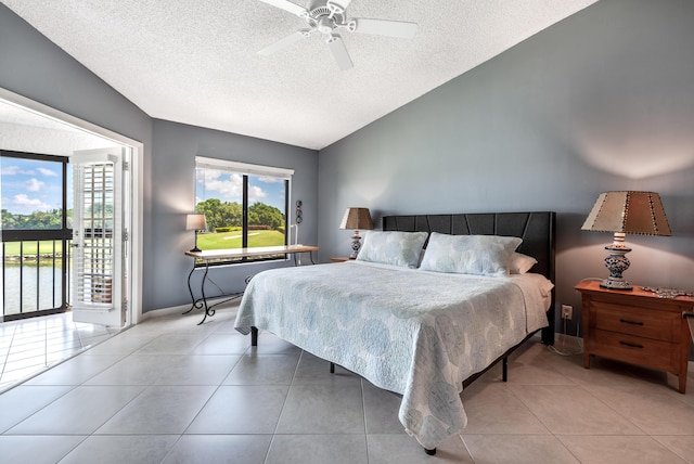 bedroom with vaulted ceiling, light tile patterned floors, a textured ceiling, and ceiling fan