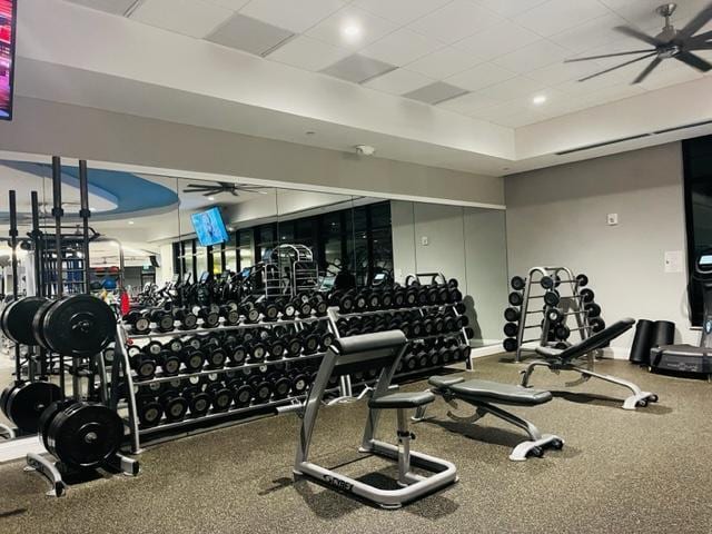 exercise room with a drop ceiling and ceiling fan