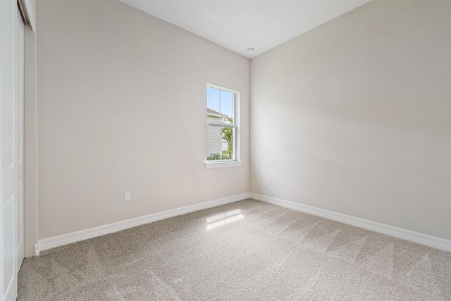 unfurnished room with light colored carpet