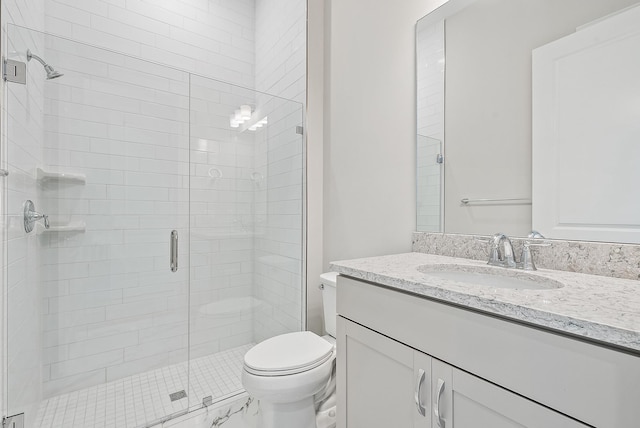 bathroom featuring vanity, toilet, and walk in shower