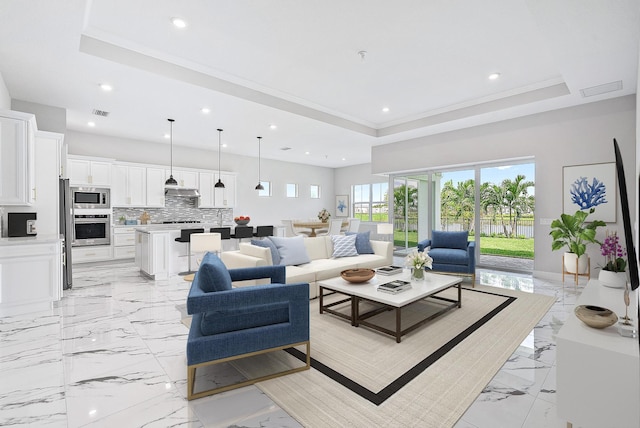 tiled living room with a tray ceiling