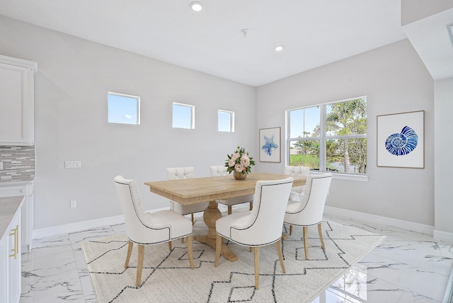 interior space featuring pendant lighting, appliances with stainless steel finishes, light tile patterned floors, and a tray ceiling