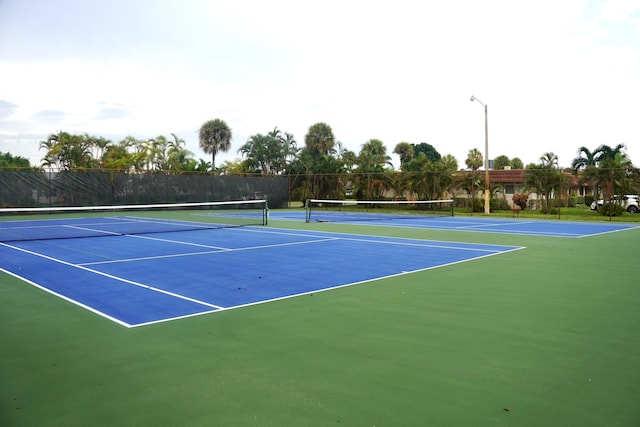 view of sport court featuring fence