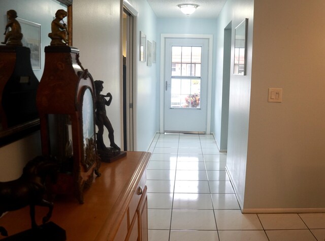 corridor featuring light tile patterned floors