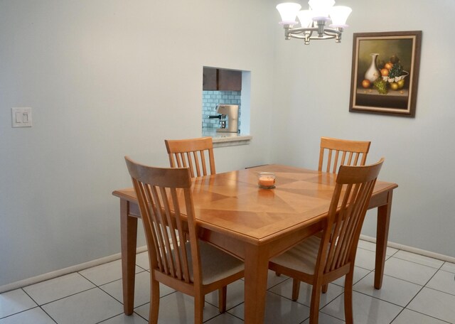 tiled dining space featuring a chandelier