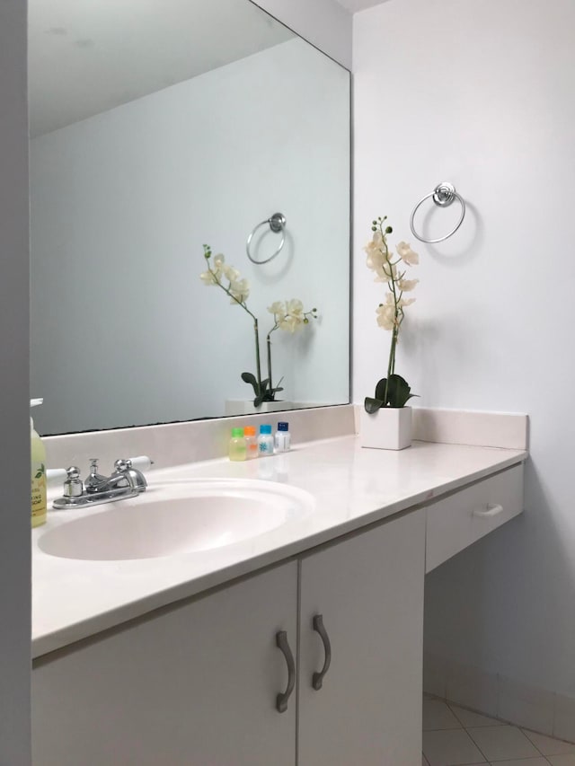 bathroom with tile patterned floors and vanity