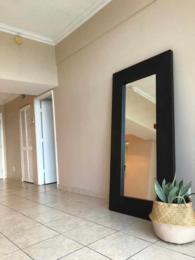 unfurnished room featuring light tile patterned floors and ornamental molding