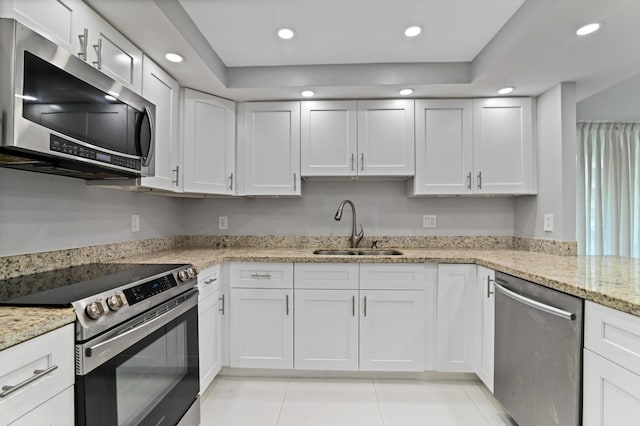 kitchen featuring sink, white cabinets, and appliances with stainless steel finishes