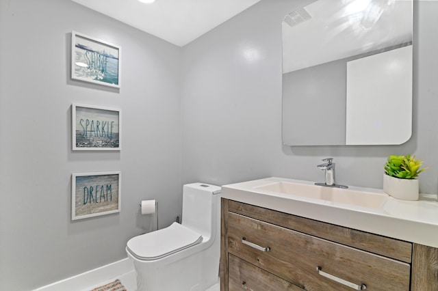 bathroom with vanity and toilet