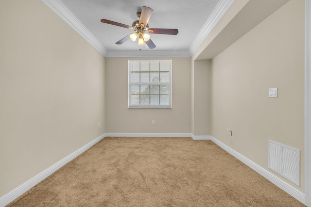 spare room with crown molding, light colored carpet, visible vents, a ceiling fan, and baseboards