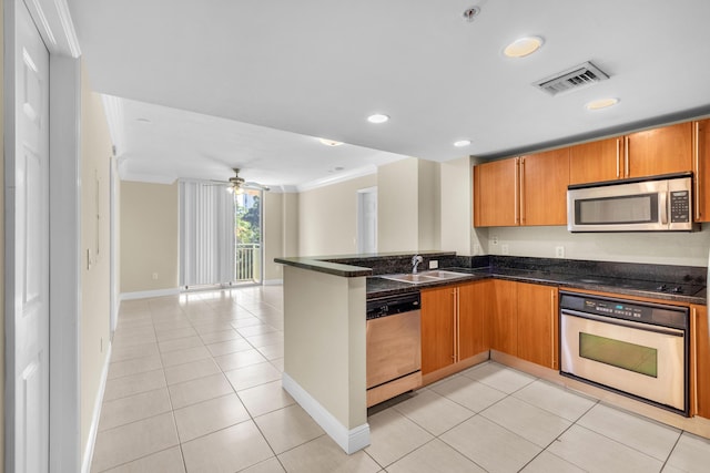 kitchen featuring stainless steel appliances, light tile patterned flooring, a sink, and visible vents