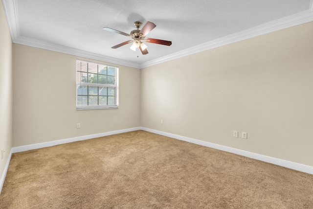 unfurnished room with ornamental molding, carpet flooring, baseboards, and a ceiling fan