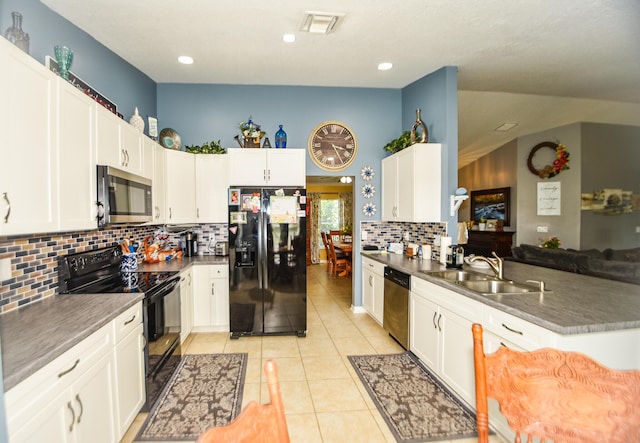 kitchen featuring dark countertops, black appliances, white cabinets, and a sink