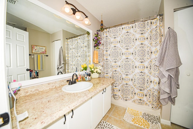 bathroom with visible vents, vanity, and tile patterned floors